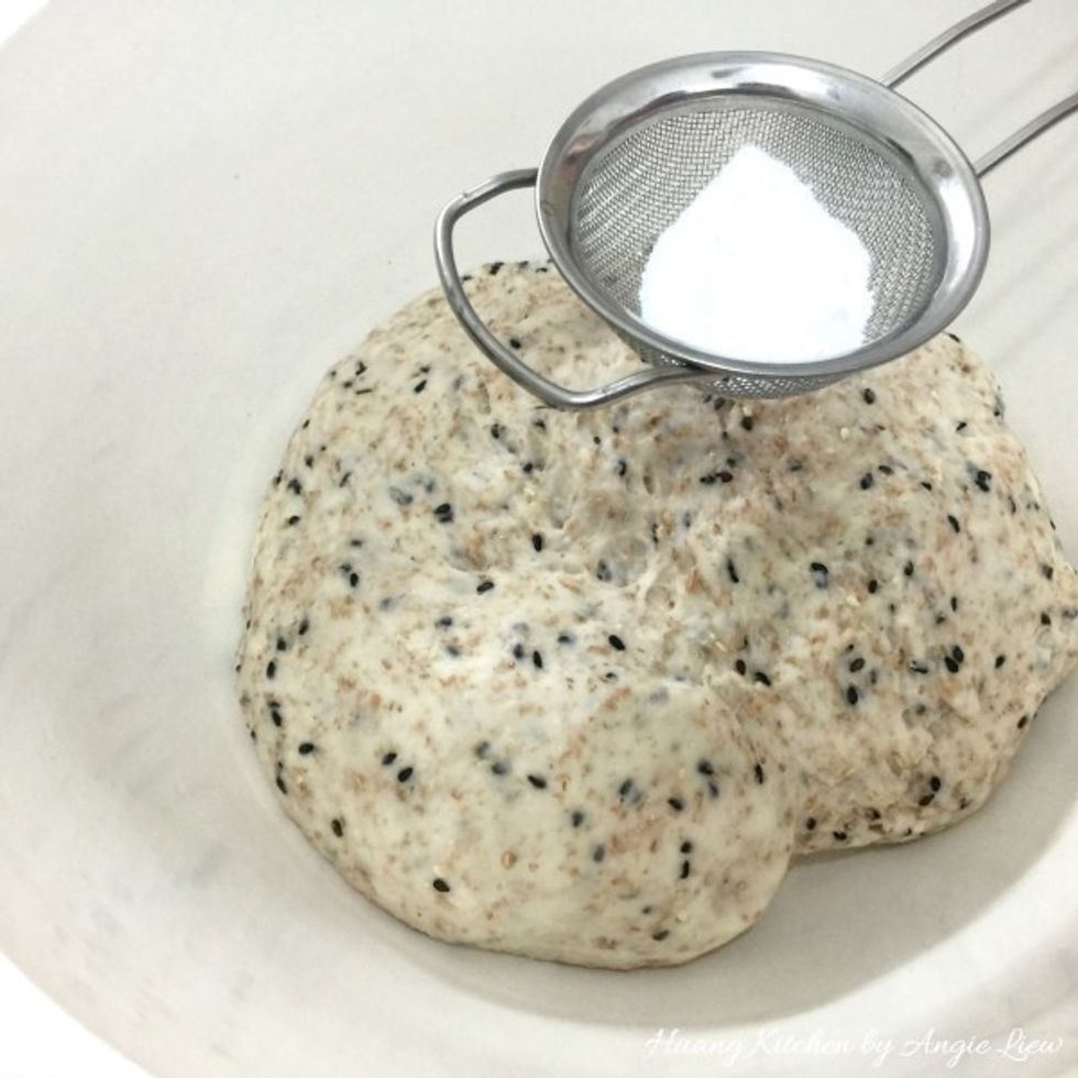 When dough has doubled in size, sieve double action baking powder on the top.