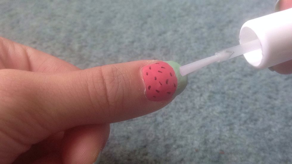 When everything has dried, finish of the design with a top coat to protect your nail art from chipping and it also helps make your nails sparkle \u2728