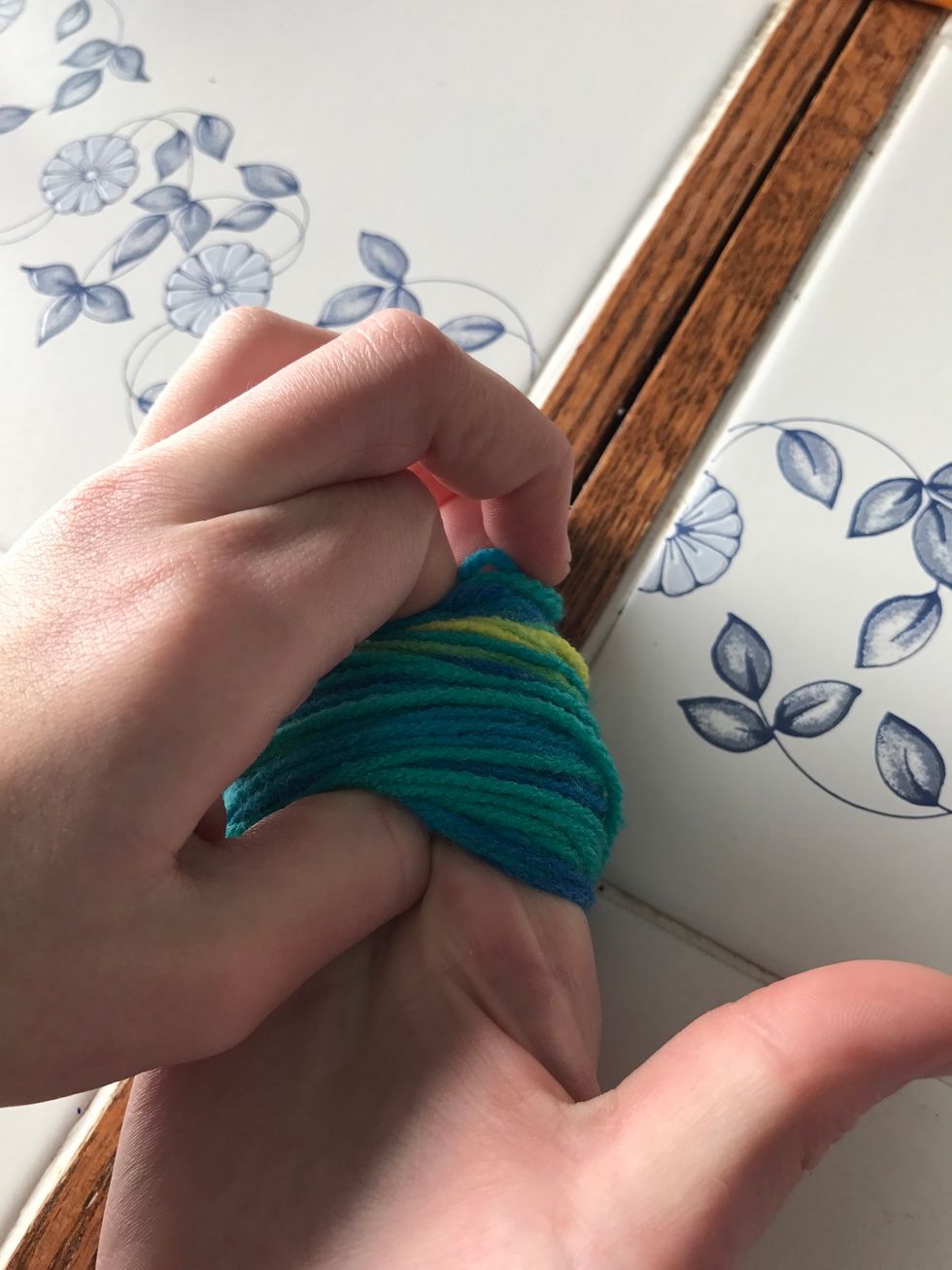 When finished pinch the yarn off your fingers, holding it with your thumb and pointer finger