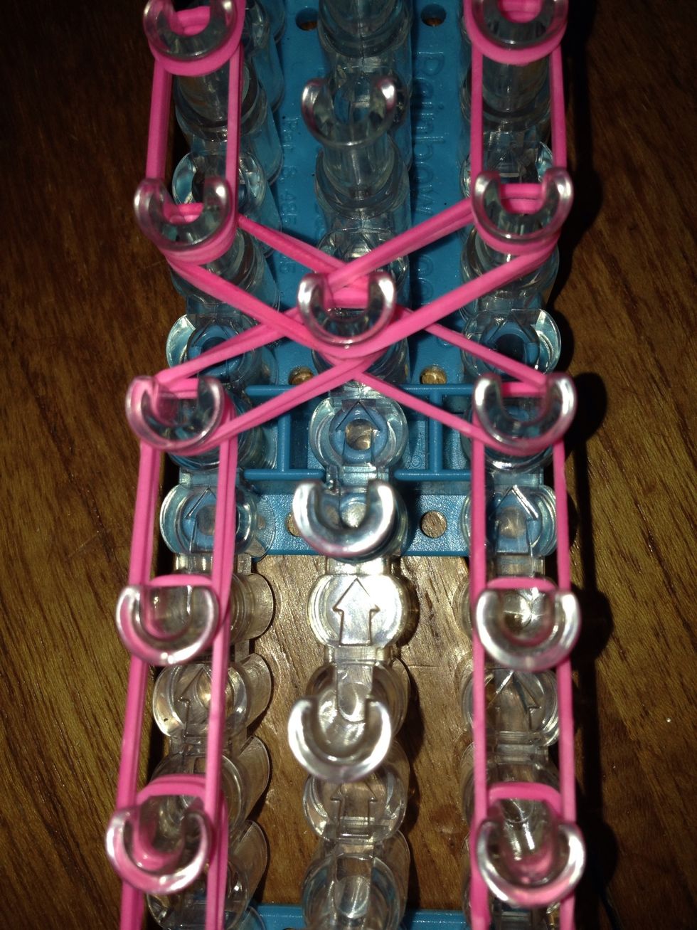 When finished the other side make an x with the bands to go to the other side.