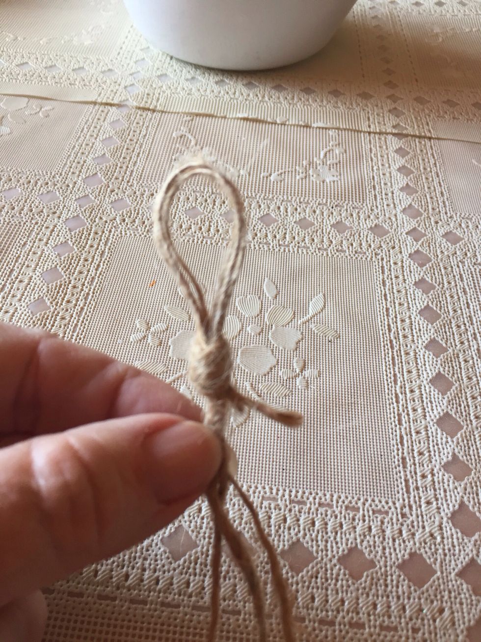 When glue is set, cut twine to desired length.  I used three lengths of twine and braided it for added strength.  Start by knotting a loop....