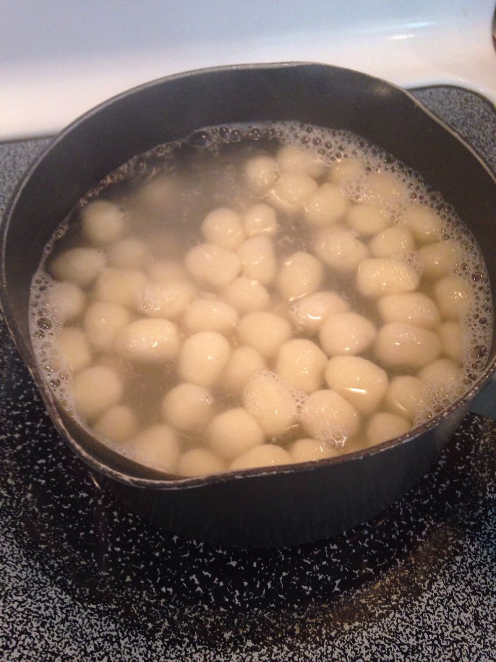 When gnocchi rises to the top of the water, they are done cooking. Drain water and set aside.