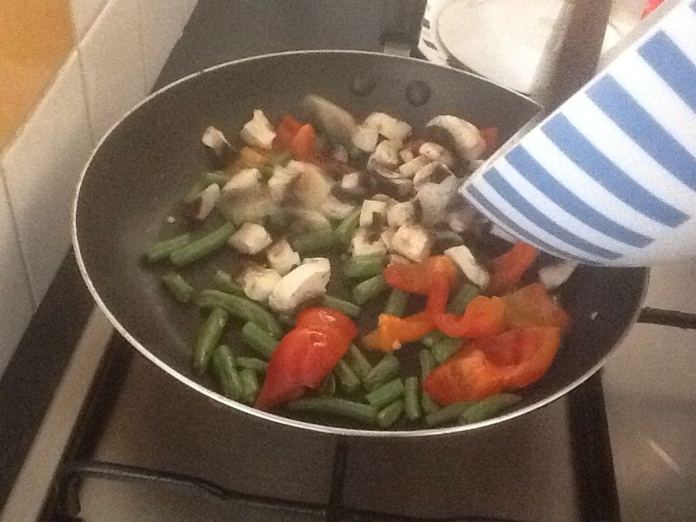 When green beans start to brown add the mushroom and stir fry.