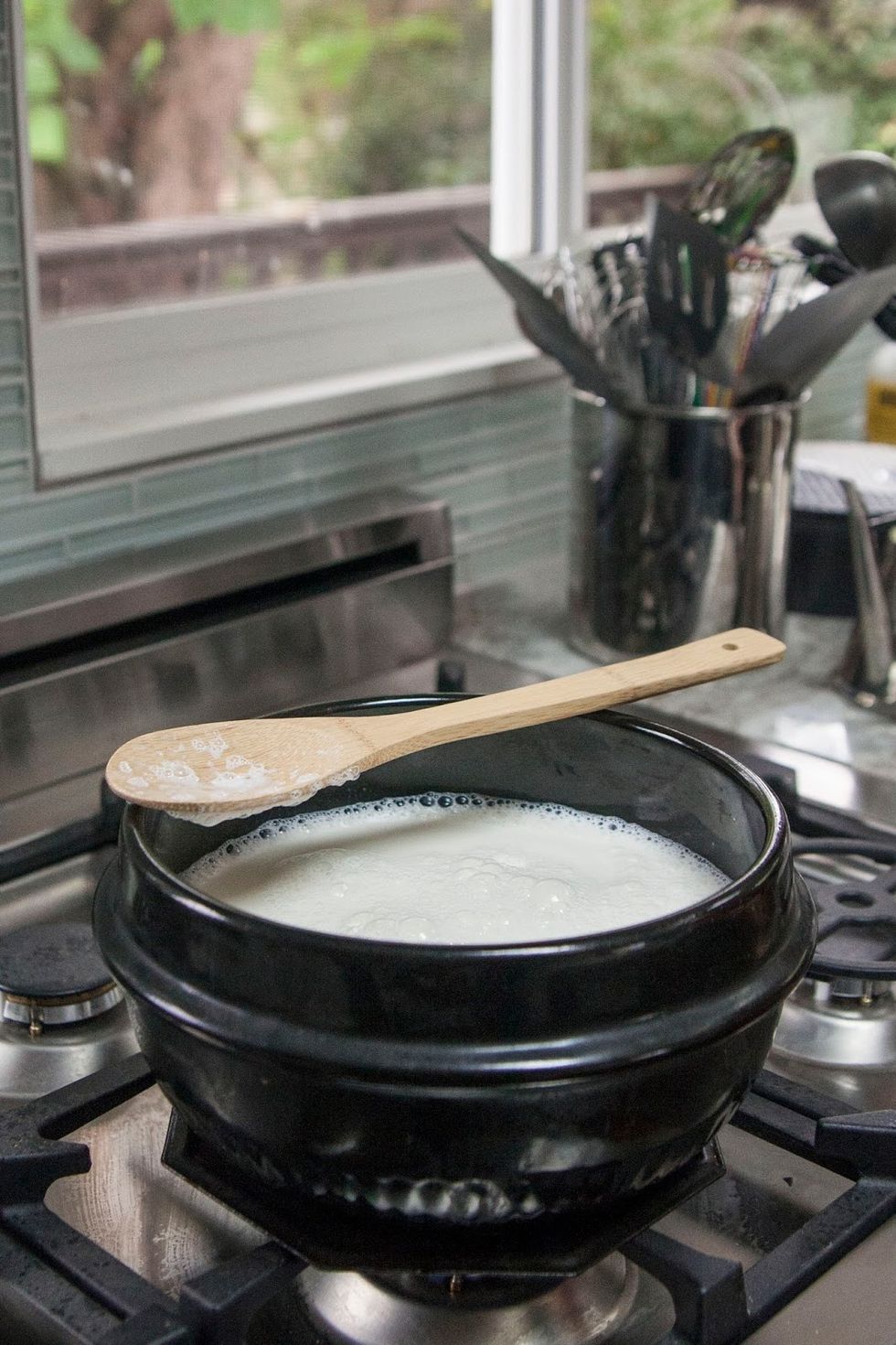 When it boils turn the heat down to low and cook it until the volume is halved. Keep a spoon nearby and stir the milk occasionally so nothing sticks.