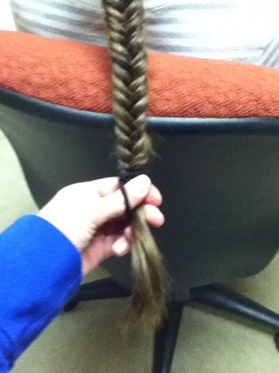 When it gets to the length you want it to be, secure it tightly with an elastic. Braid a little past the length you want in case some comes apart while your tying. Pin up loose strands with bobby pins