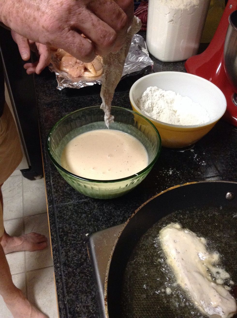 When it is clear that the oil is beginning to boil dip your chicken into the batter,then into the flour and then into the frying pan.
