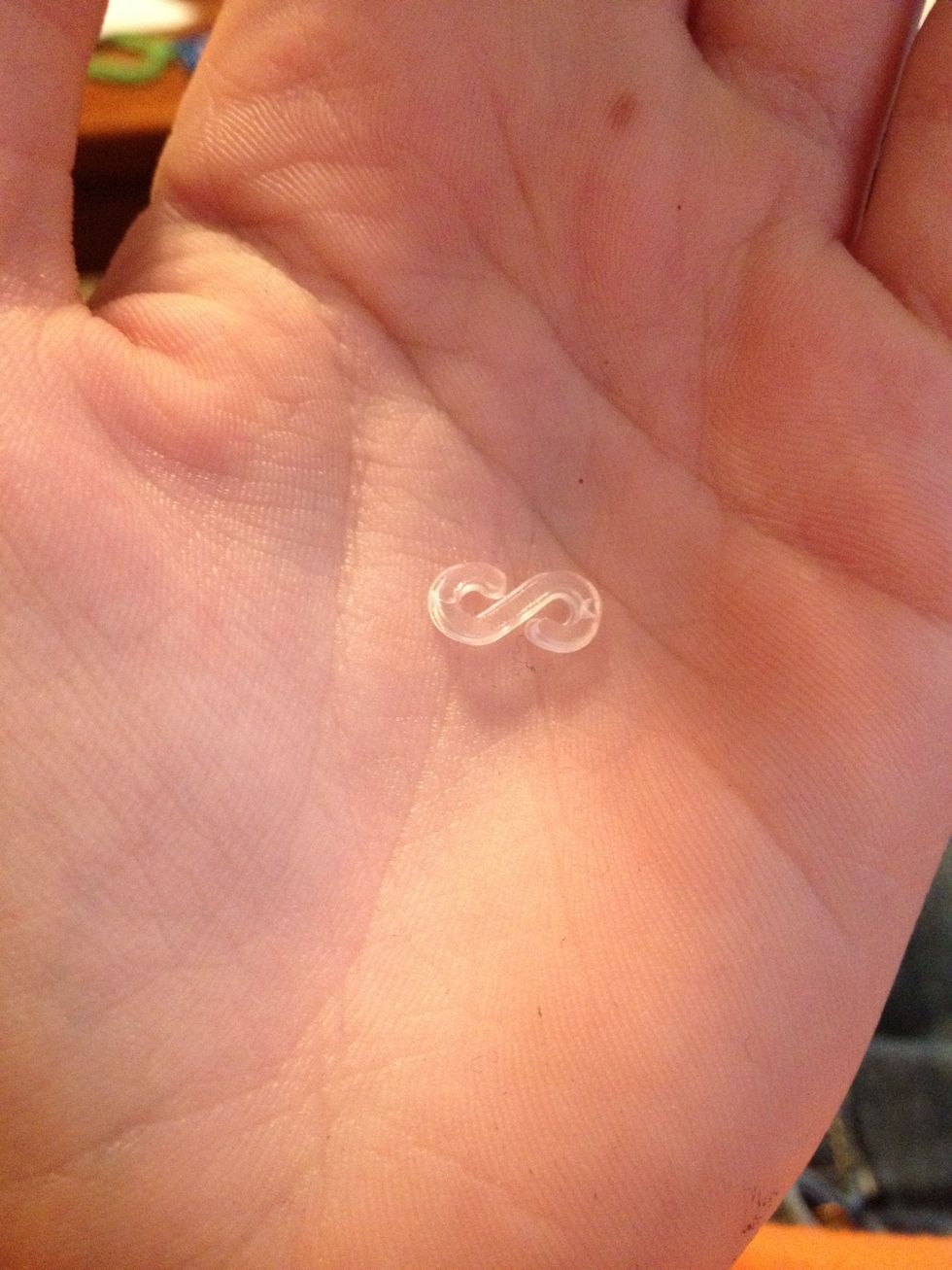 When it reaches the desired length, add one of these clips to close it off. One side of the clip hooks one loop of the bracelet and the other side for the other loop.