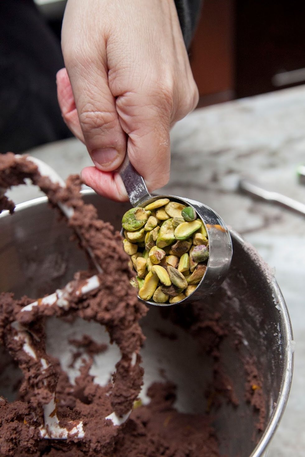 When it's blended together, fold in the pistachios by hand. The dough is stiff, so  that's why you want to add the pistachios by hand.