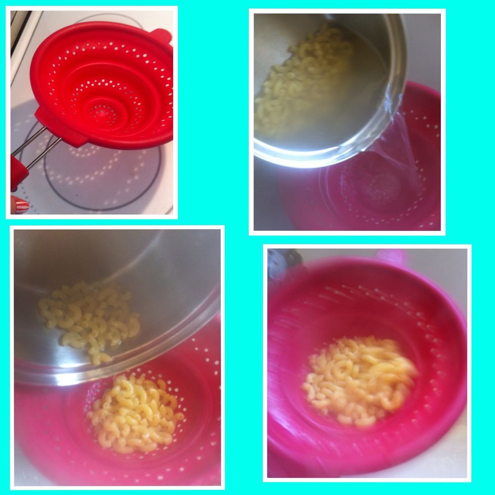 When it's done get your strainer and place it over the sink. Pour the pasta into it. Now remember the water is boiling. Be CAREFUL! Don't let it splash. Shake out the water.