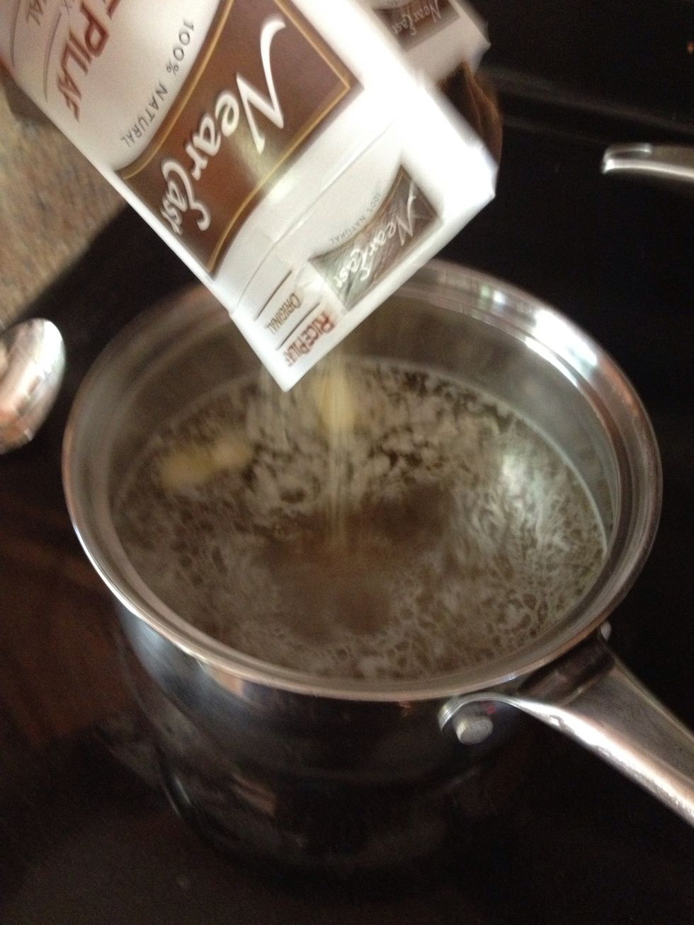 When it's to a boil, add in both boxes of rice pilaf and the seasoning packets and stir.