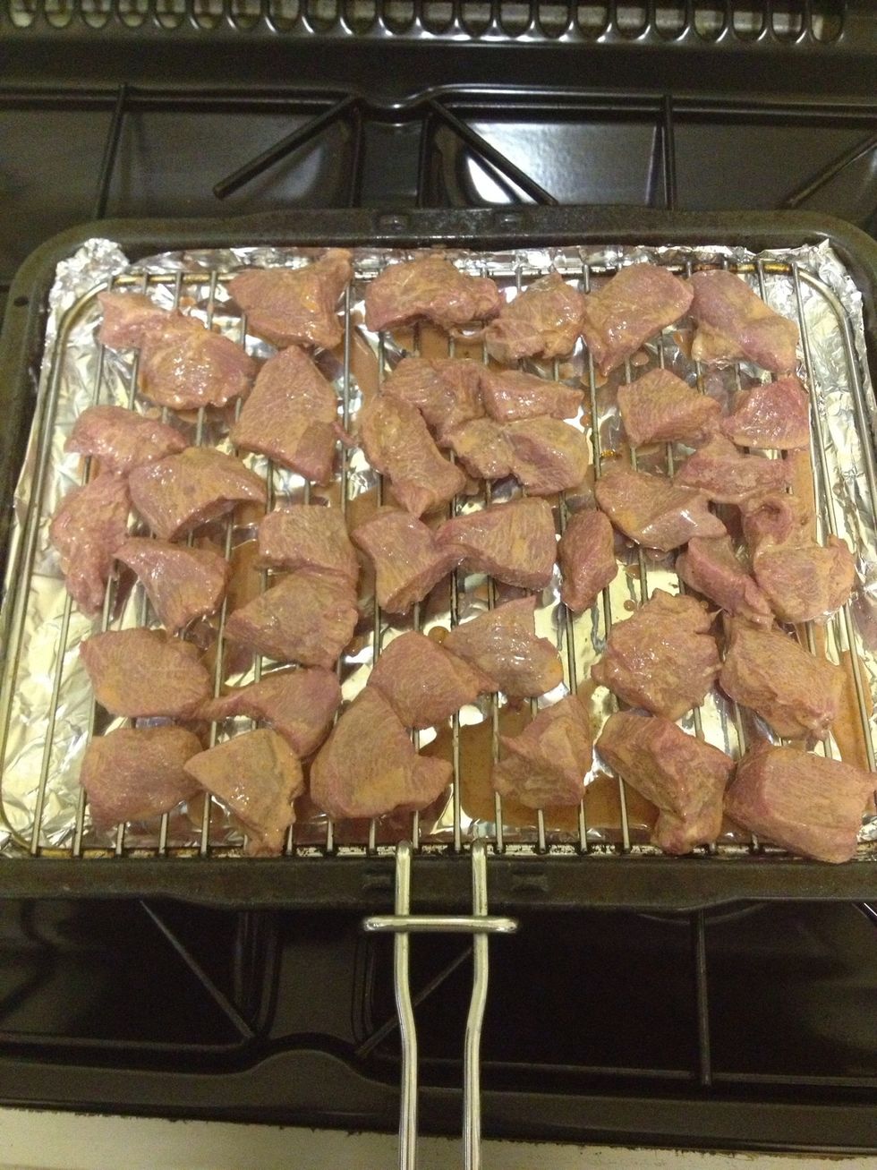 When its time to eat turn your oven on full and lay out your chicken pieces on a grill rack like this. Let excess marinade drop off back into the bowl whilst doing this, I used tongs to save mess :0)