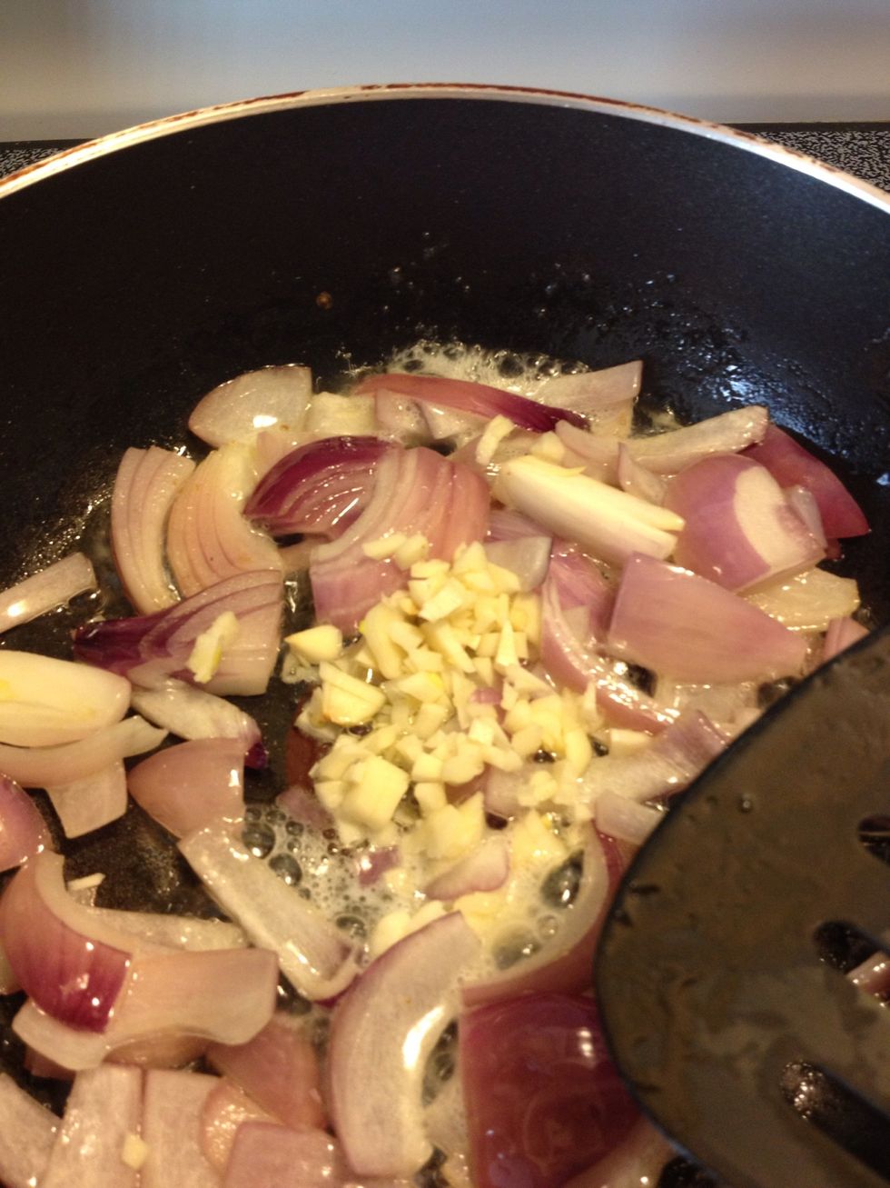 When lightly pink, add garlic and saut\u00e9 for a minute