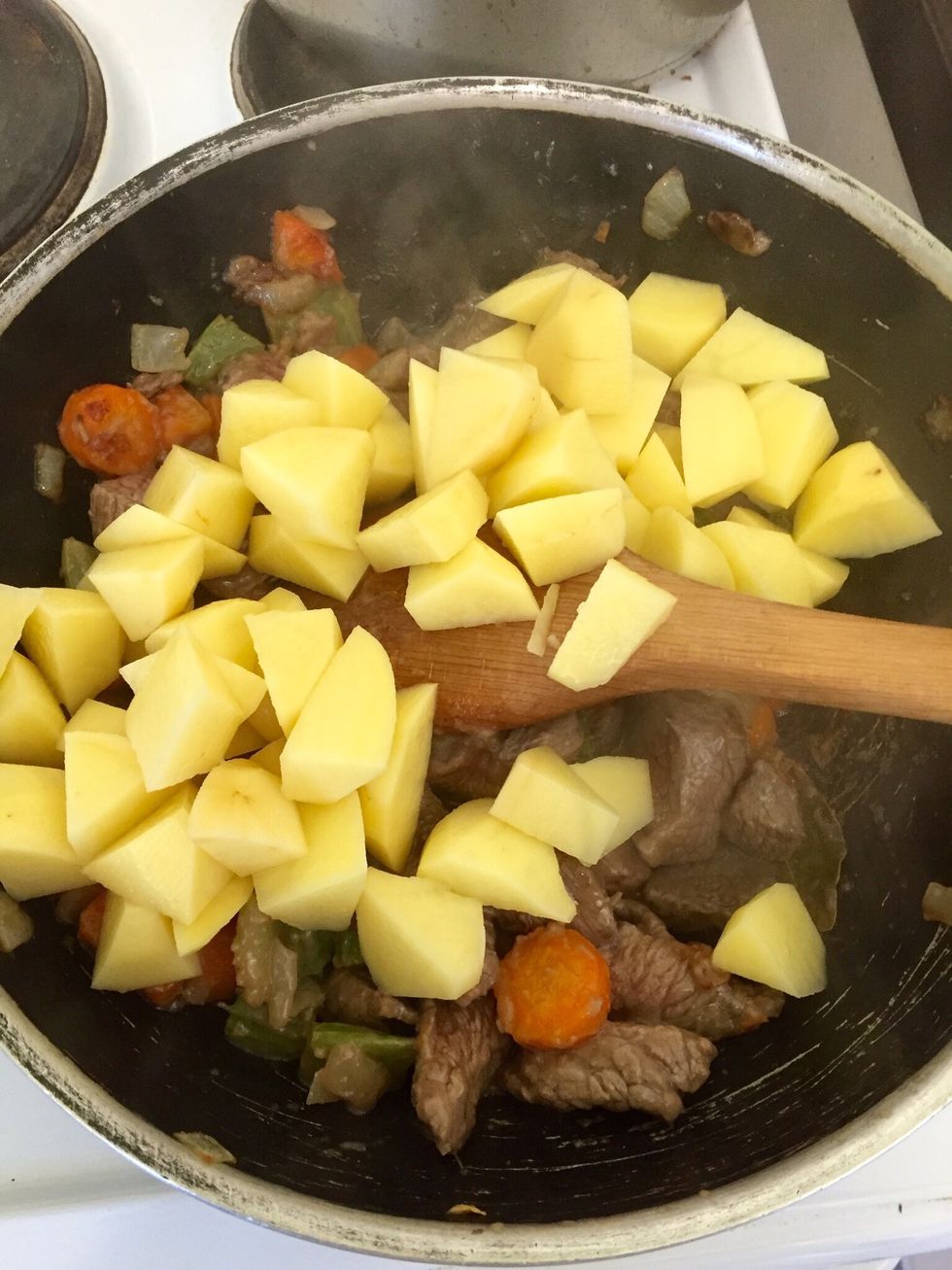 When meat is brown add the potatoes and stir for a bit