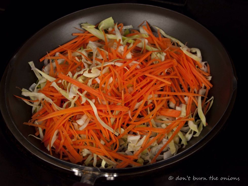 When oil is hot add sliced cabbage, carrot and leek. Fry over high heat for about 1 minute stirring frequently to stop it burning. Then add chopped ginger.