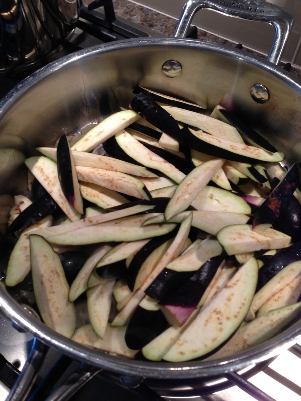 When oil starts sizzling add eggplant