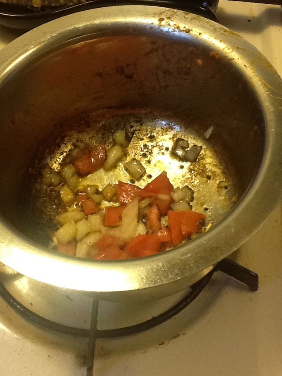 When onions turn golden brown add chopped tomatoes and salt