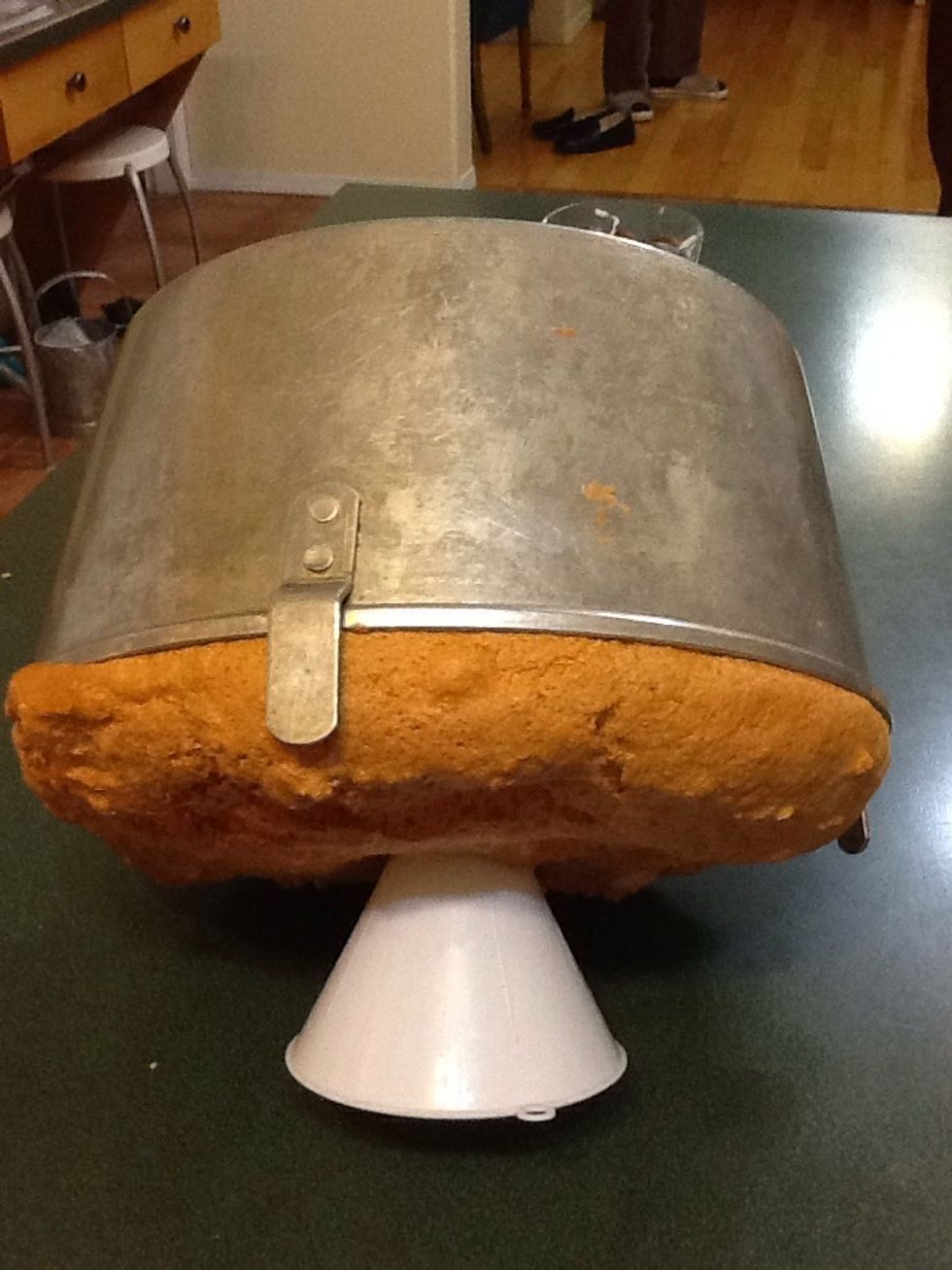 When out the oven put the cake upside down until cool complete  then you can work to take it out from cake form with spatula .