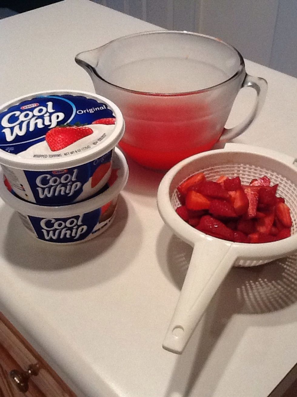 When partially set remove from fridge and add strawberries and one and a half tubs of Cool Whip. (Yes, this is what makes it a Strawberry DREAM pie!)