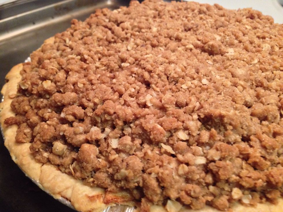 When pie is done, remove from oven. Reduce heat to 375 F. Carefully coat the entire strudel topping over the pie. Make sure to completely cover it right to the edge. As you pile gently press into pie.