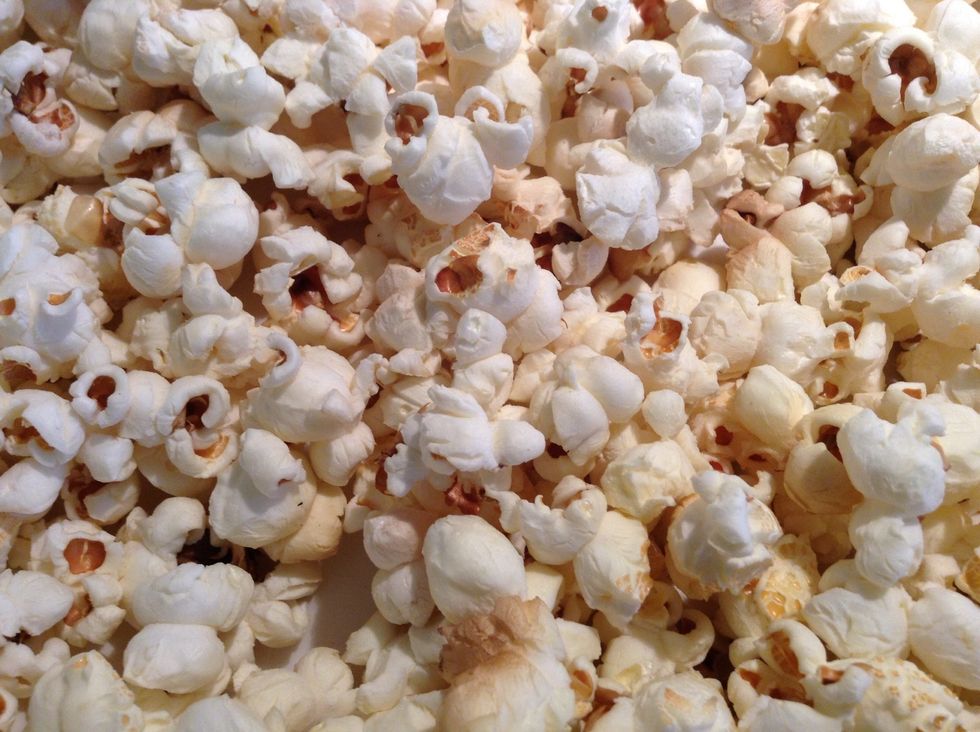 When popcorn has stopped popping (you will hear) take off heat and pour into a big bowl