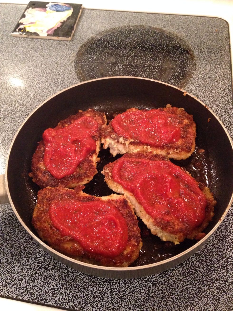 When pork is no longer pink on inside, remove from heat. Add some spaghetti sauce to the top of each pork loin.