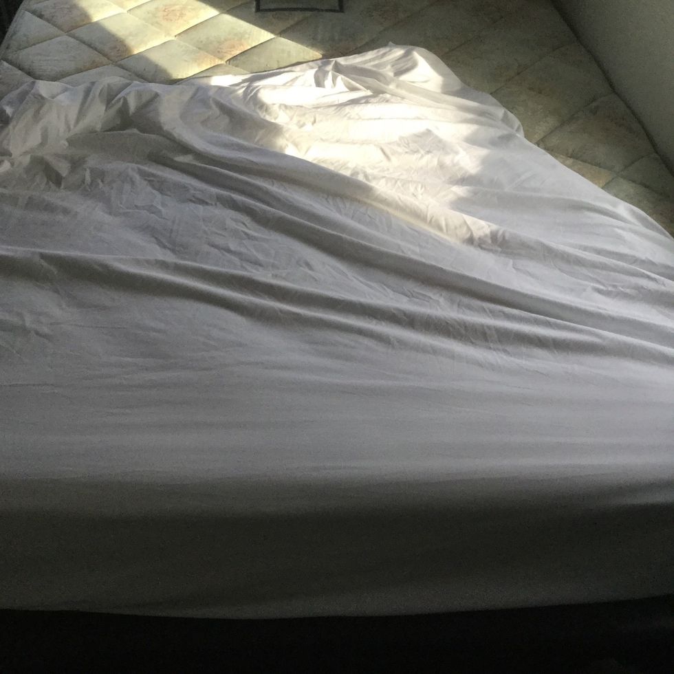 When putting on a fitted sheet start at one end of the bed and be sure to tuck the corners of the sheet under the mattress.