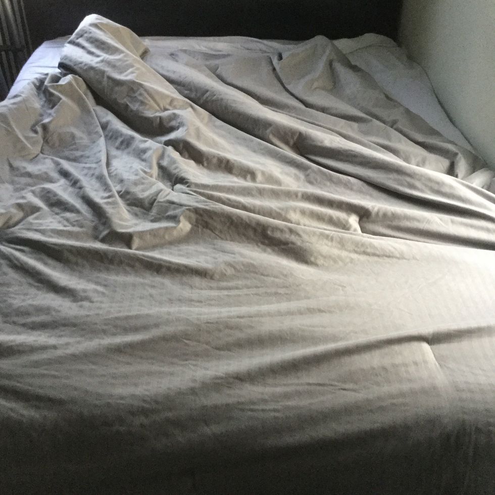 When putting on the comforter, it's best to do this the same way the flat sheet was put on with the fluffing technique. You can tuck the excess under the mattress for an extra tucked-in feel.