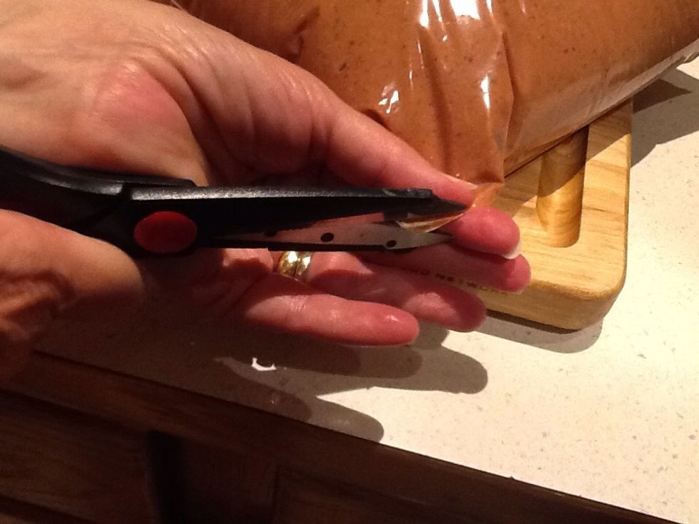 When ready to make muffins, cut a small corner off the bag, pick it up holding the corner.