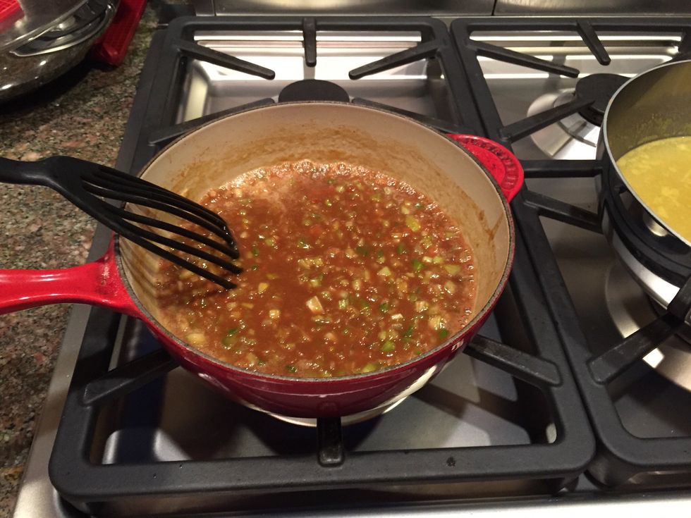 When roux, onion, celery, bell pepper have darkened slightly, stop stirring constantly and move to next step.
