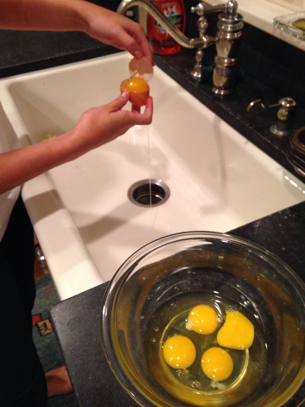 When separating the eggs, make sure to save the egg whites because they will be used later on in the recipe, combine the three whole eggs with the three egg yolks in the heat proof mixing bowl.