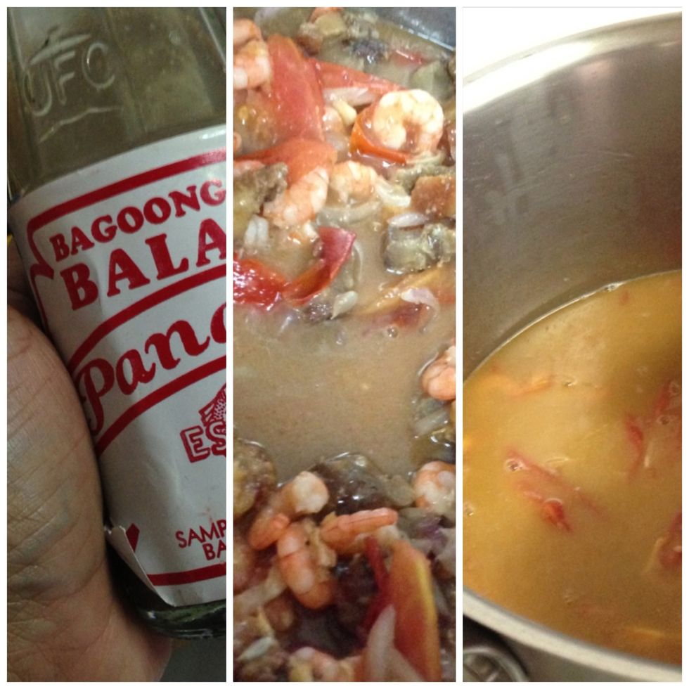 when shrimp is cooked, add bagoong (shrimp paste) balayan. cook for 30 seconds and add water. wait for it to boil.