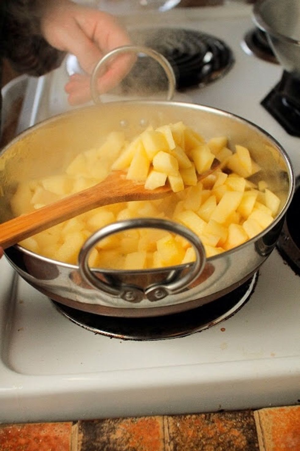 When the apples have softened add 2 Tbs of water. Turn the heat down to medium low and cook the apples down for 15 minutes or so. Stir them occasionally, so they don't stick.