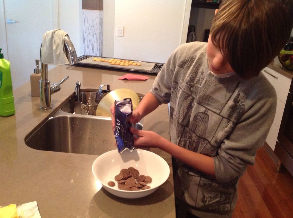 When the biscuits are baked to perfection, cool them down for 10 mins. Then grab a packet of chocolate melts and pour inside a bowl to melt inside a microwave.