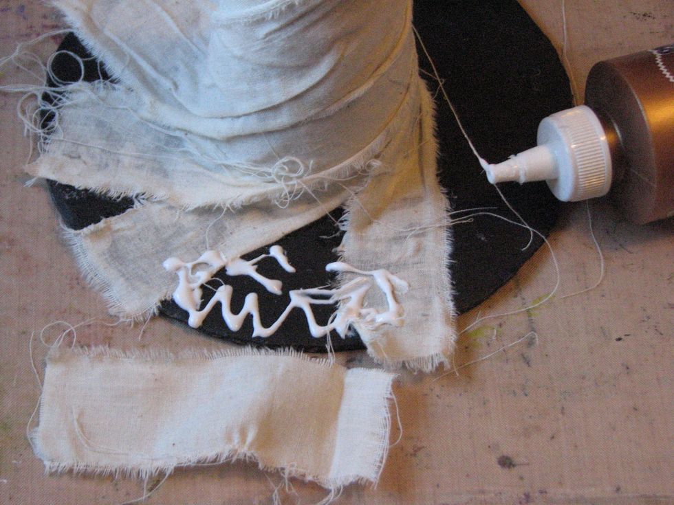 When the body of the hat and curly-q has been covered you may have sections along the brim that haven't been covered.  Tear smaller strips of muslin and cover those exposed areas.