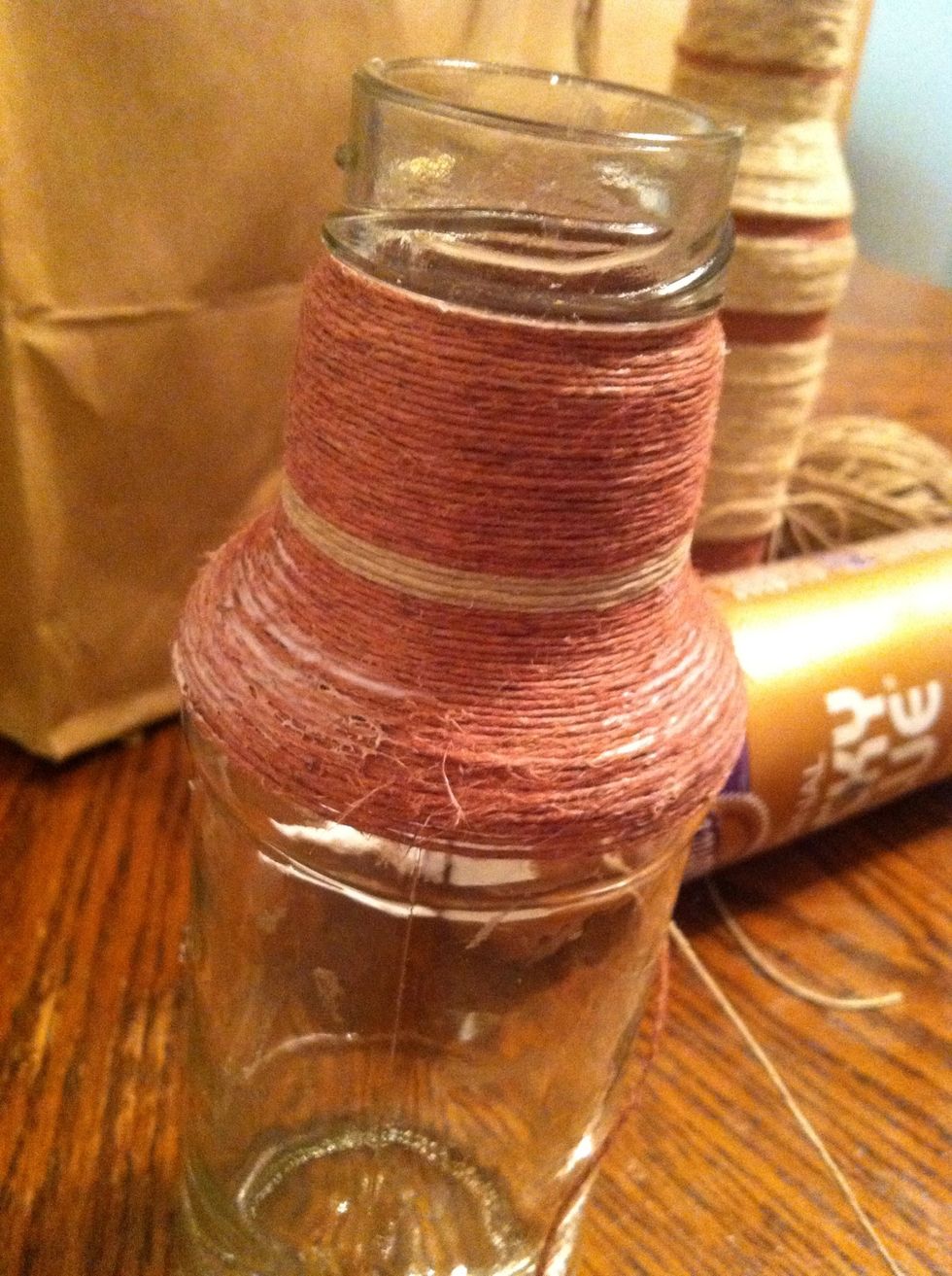 When the bottle begins to widen add glue in more places than the back to prevent slippage. I added to the sides so it would mimic reflective light. If wrapping down a sloping bottle, flip over.