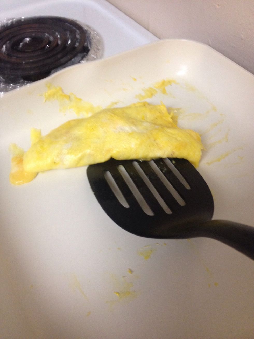 When the bottom is cooked, flip the omelet in half