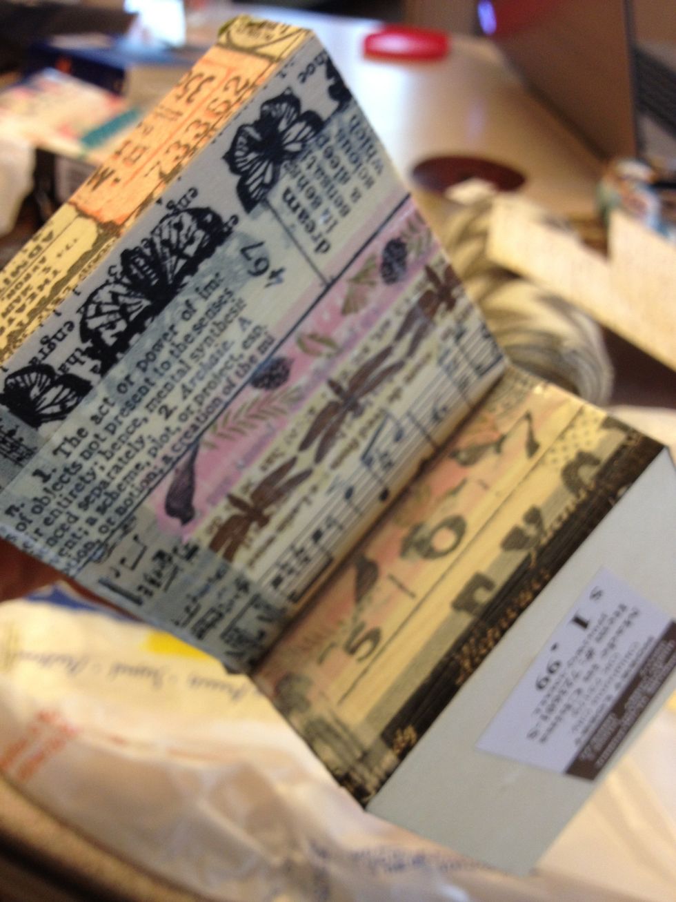 When the box is completely covered with the tape, cover the entire thing with mod podge or gel medium to help the tape stick and also to protect it from sun damage and give it a finished look. Let dry