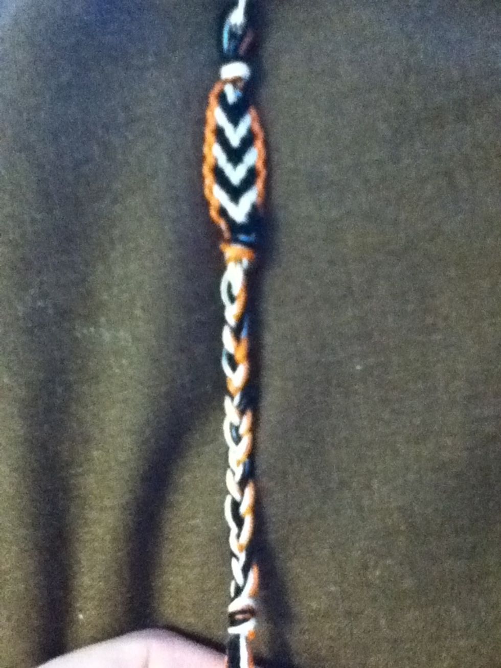 When the bracelet is the desired length, tie it off. Then either braid a few inches or thread on the toggle and make a knot.