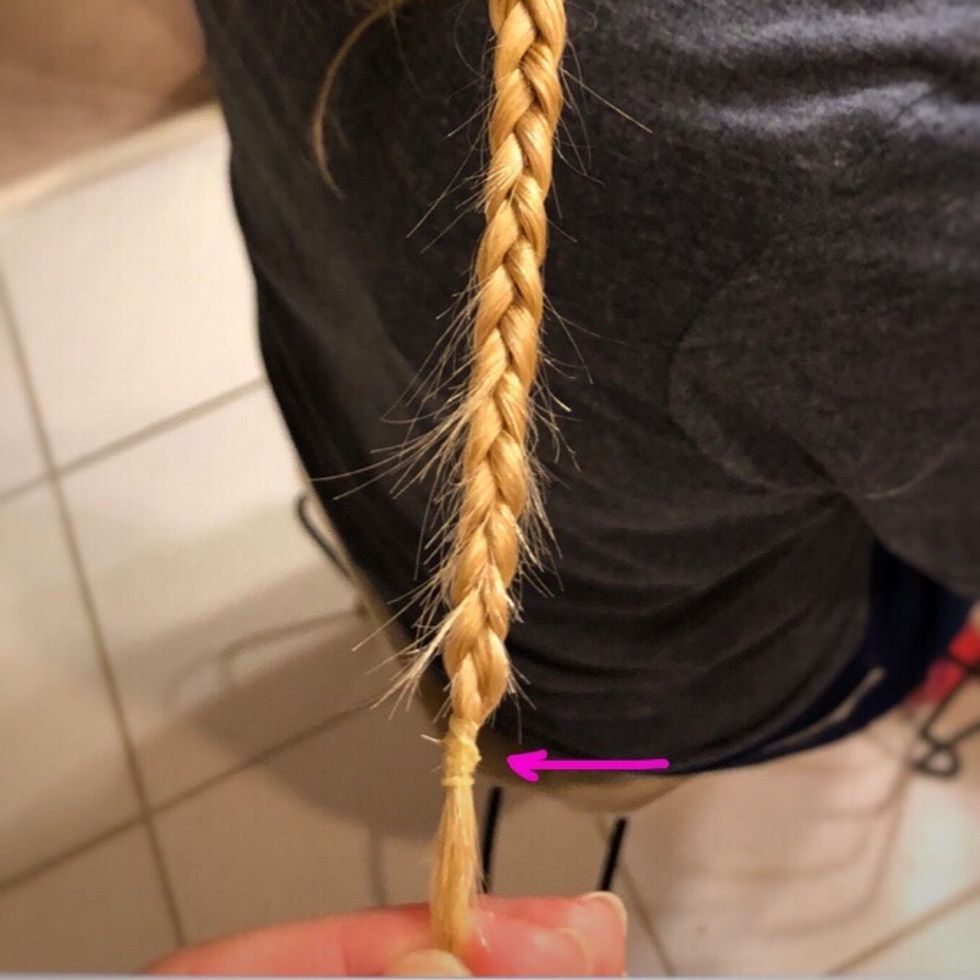 When the braid is as small as it can go, take a small rubberband and wrap it as many times as needed around the braid.