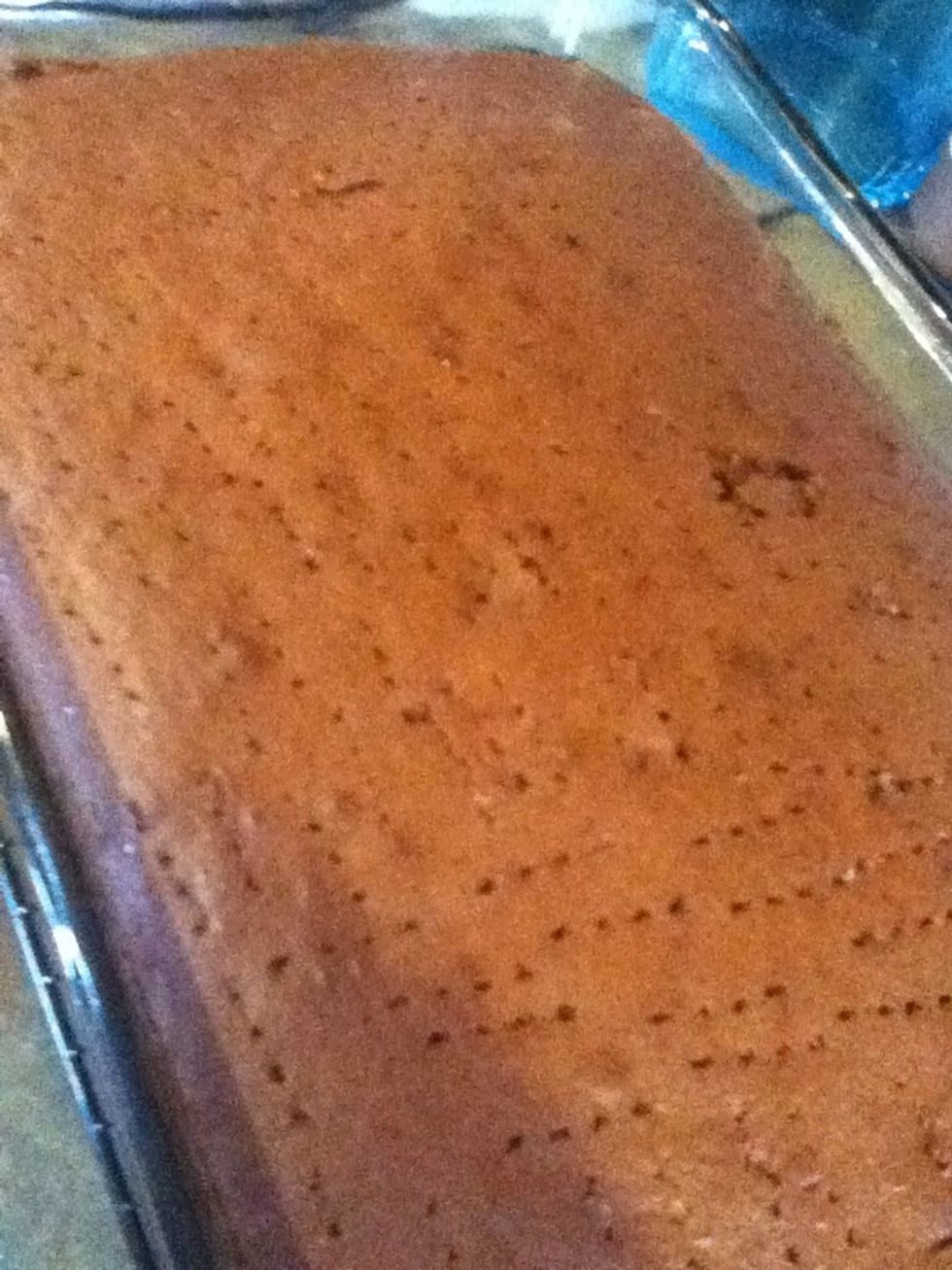 When the cake is out of the oven. While still hot use a fork and poke full of holes.