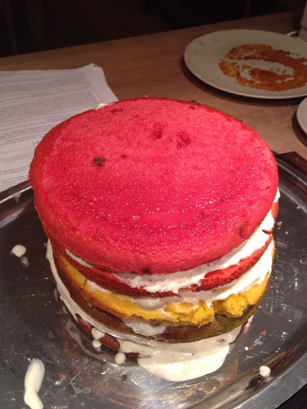 When the cake is stacked, frost it on the outside. Then put it in the fridge to cool down