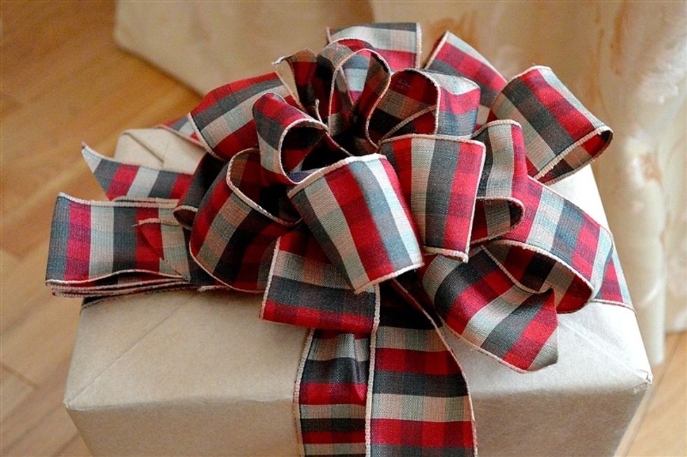 When the center is fluffed, start twisting and fluffing the longer lengths of accordion folded ribbon for the outer section of the bow.