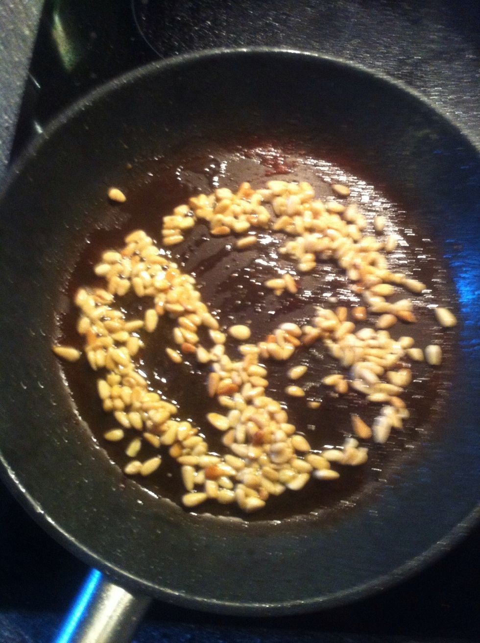 When The chicken is done, put lots of olive Oil on The pan. 1 dl / 8 table spoons. Put The pine nuts on The pan as well. Fry for 1 minute. Make sure they dont buuuurrn!!