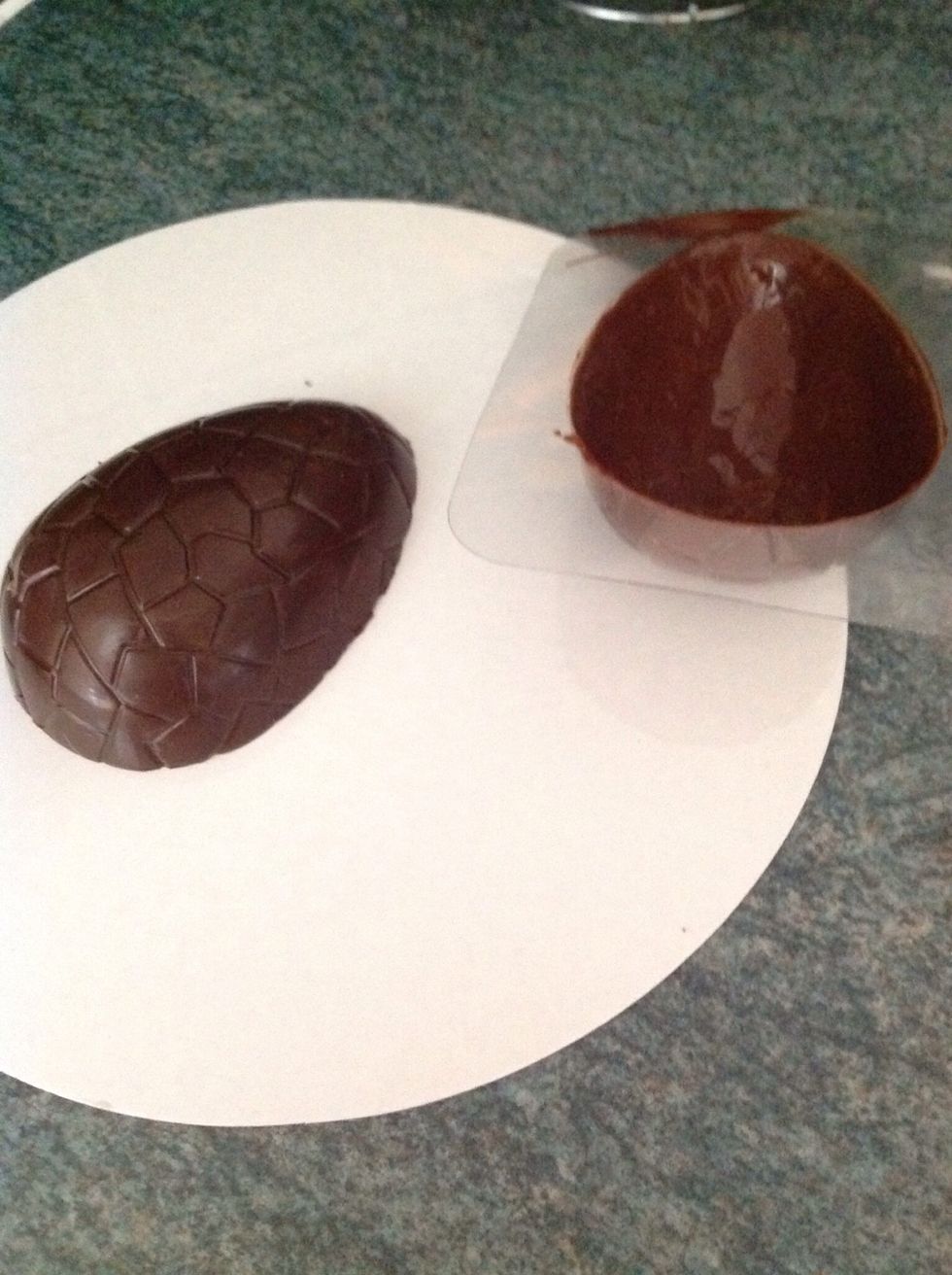 When the chocolate is fully cooled and set, carefully remove the first half of the egg by placing upside down and gently pull the mould, the egg should pop right out, then repeat the process again