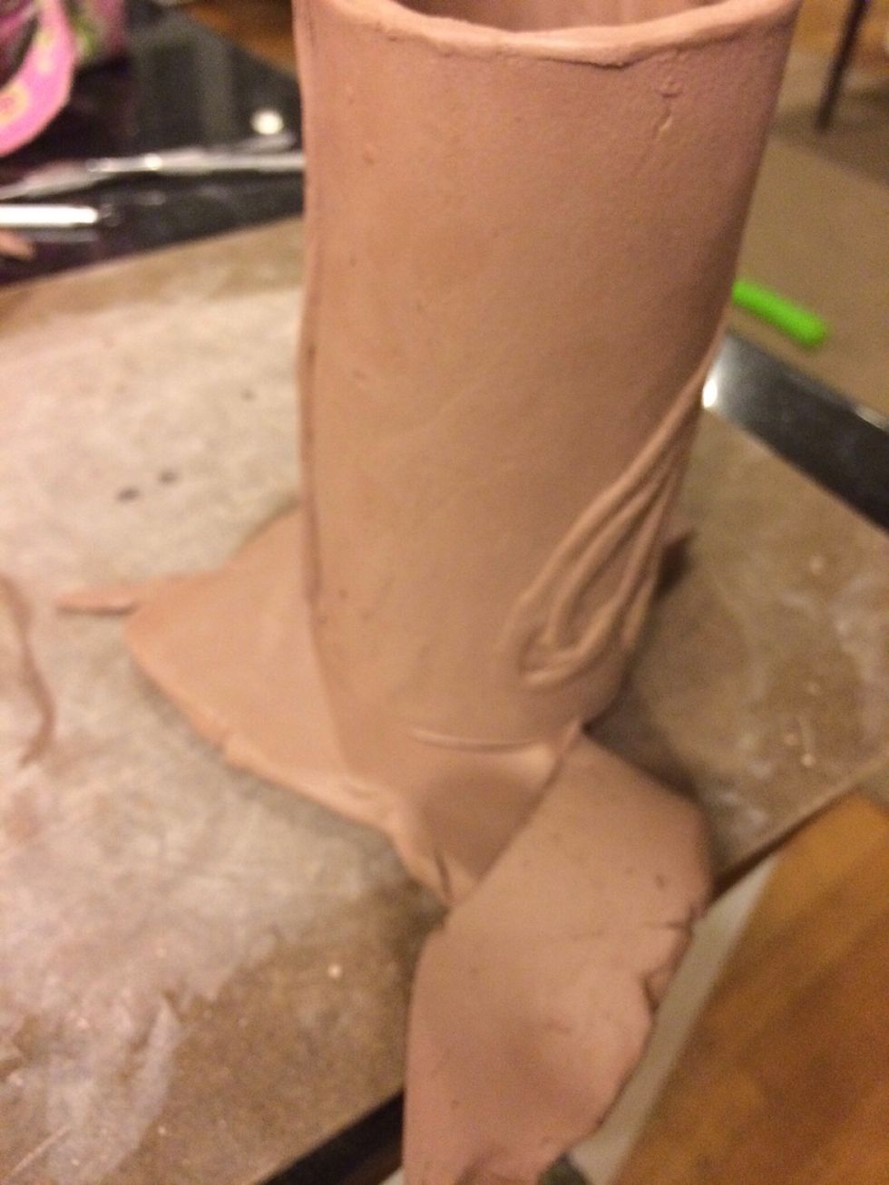 When the clay has set up, start construction. This cup is going to be a tumbler. Set the cup on top of a small slab and trace around your cup. This will be the bottom of your cup.