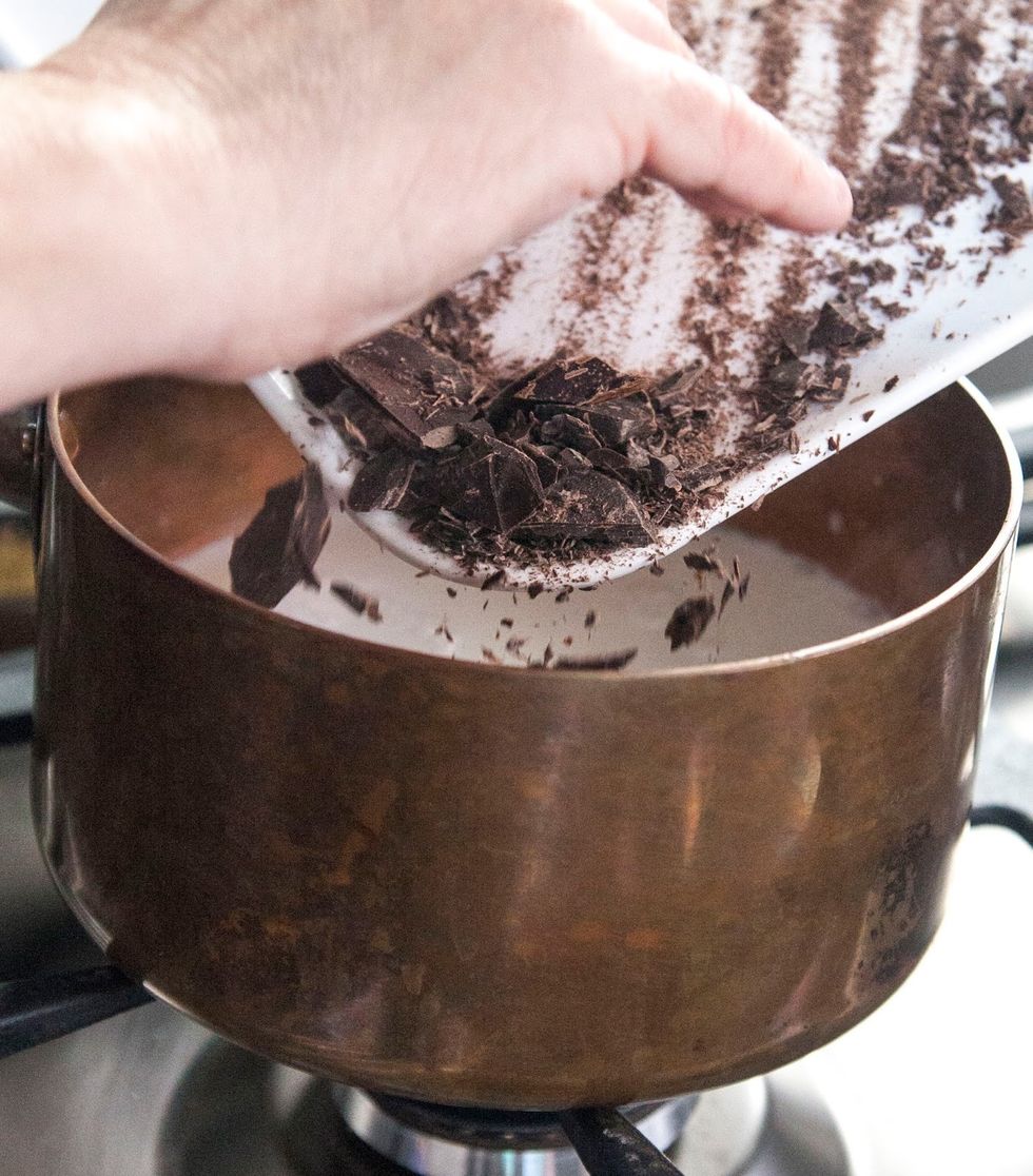 When the coconut milk is warm (not boiling!!) add in the chunked chocolate. Melt the chocolate into the warm coconut milk. Stir it and make sure it's well blended.