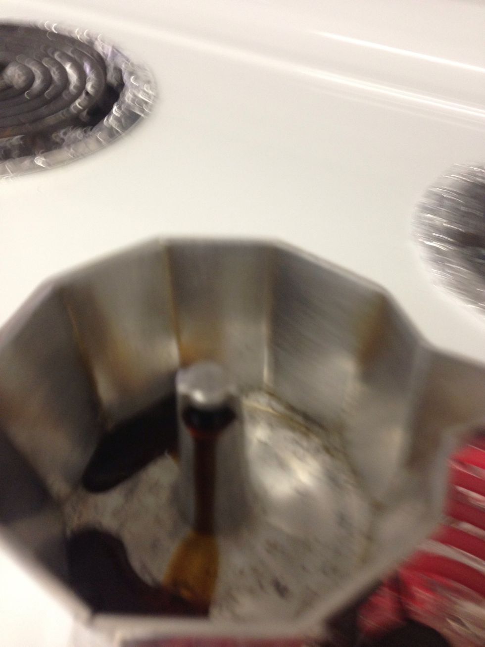 When the coffee starts coming up pour a small amount into the sugar.