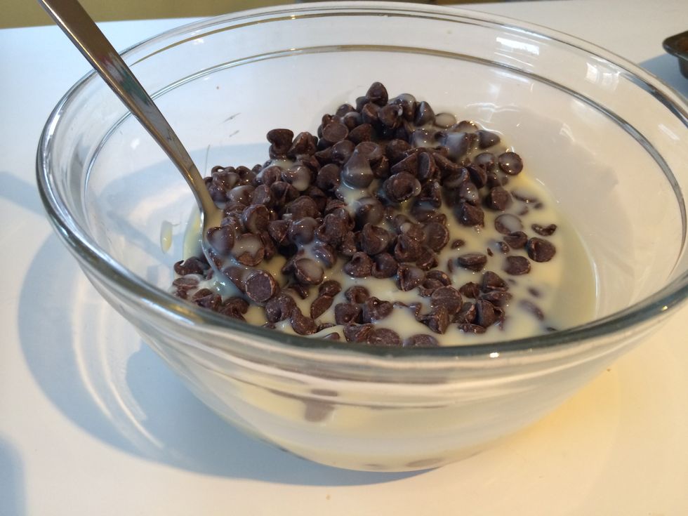 When the cookie pan has cooled, mix together the chocolate chips and sweetened condensed milk.  The better quality chocolate used, the better the fudge.