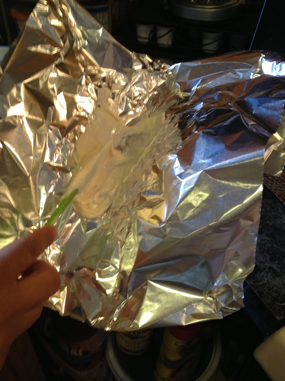 When the corn is ready, take a piece of foil and add a tbs or more of mayo.