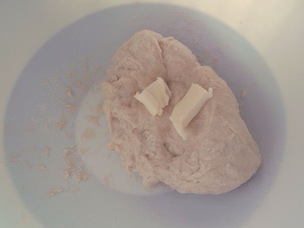 When the dough becomes less sticky, mix in the softened butter.